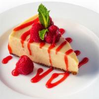 Ny Style Cheesecake · Creamy cheesecake with a graham cracker crust finished with raspberry sauce and mint.