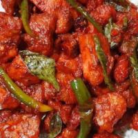 Chicken 65 · Deep fried chicken chunks in spicy, red chili sauce with peppers and curry leaves. Smoky hot