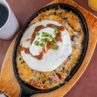 Huevos Rancheros · Pulled pork, black beans, onion, mixed cheeses, topped with two eggs cooked your way, enchil...