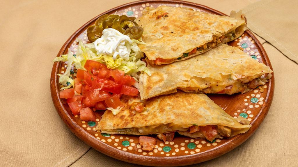 Quesadillas · Ten inches flour or corn tortilla stuffed with mozzarella cheese cilantro, onions, and your choice of meat.