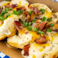 The Aretha Franklin · Biscuits, gravy, sausage, thick sliced peppered maple bacon, colby jack cheese and chives.