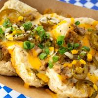 The Village Biscuits · Biscuits, gravy, sausage, jalapeños, colby jack cheese,and chives.