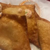 Crab Puffs · Wontons filled with crab meat, cream cheese, bits of carrot and celery