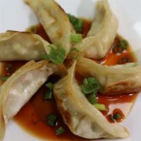 Pork Gyozas · Pan seared dumplings stuffed with pork meat. Comes with house soy dipping sauce