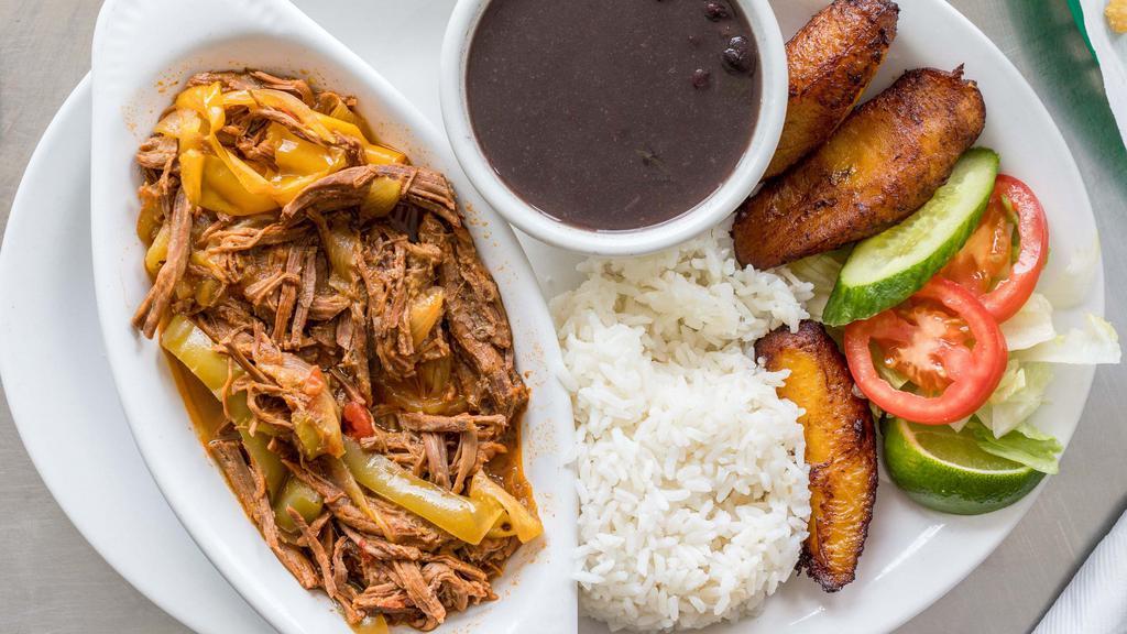 Ropa Vieja · Shredded brisket cooked with sofrito sauce.