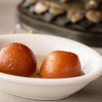 Gulab Jamun · Pastry balls in honey flavored syrup.