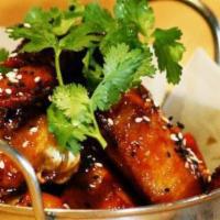 Thai Chicken Wings · Four jumbo whole wings, fried then wok-seared in our lemongrass-chili glaze has red boat, ri...