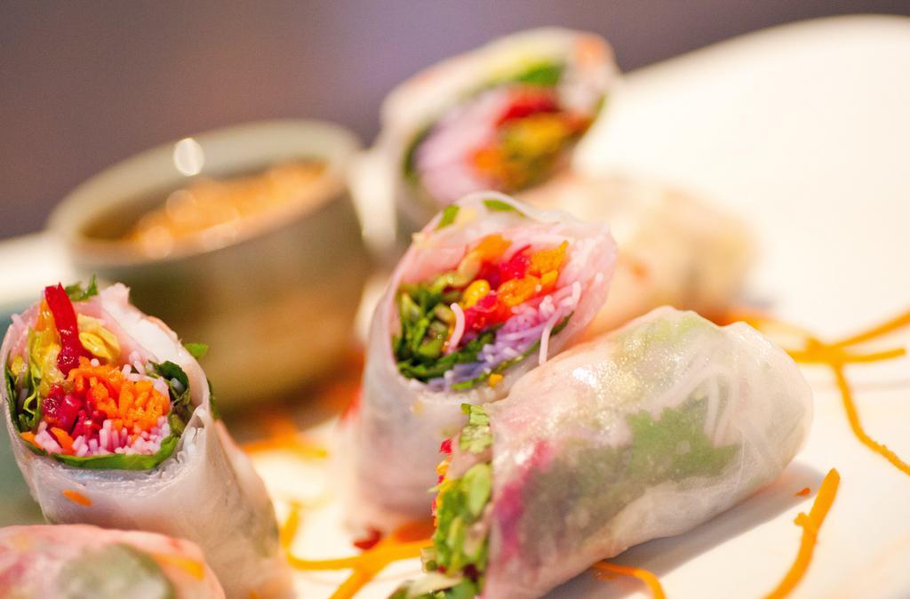 Spring Rolls Tuna · Three fresh rice paper salad rolls with lightly seared sushi-grade ahi tuna, rice noodles, mint, and cilantro. Wrapped with pickled bean sprouts, carrots, lettuce, and green onions. Served with nuoc mam and peanut sauce.