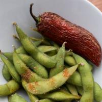 Edamame · Steamed and tossed in a spicy seasoning blend. Served with blistered red jalapeno.
