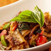 Drunken Noodles / Pad Kee Mow · Wok-seared fresh flat jasmine rice noodles in a spicy soy, with beef tenderloin and Thai bas...