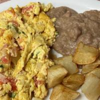 #4 Huevos Mexicana · 2 Eggs scrambled with onion, tomatoes, green jalapeño peppers, served with Rice and Refried ...