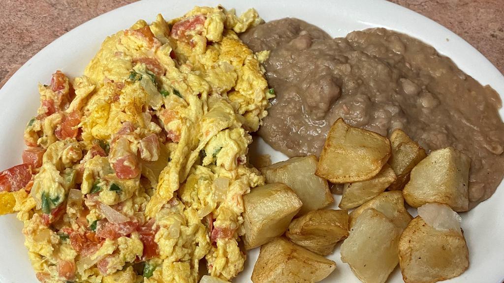 #4 Huevos Mexicana · 2 Eggs scrambled with onion, tomatoes, green jalapeño peppers, served with Rice and Refried Beans.