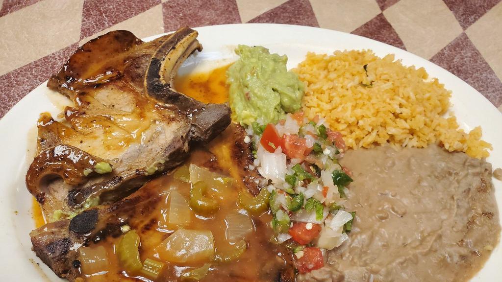 #8 Pork Chop · 2 Eggs any style, 1 Pork Chop topped with Salsa Ranchera, served with Potatoes and Refried Beans.