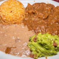 #4 Carne Guisada Plate · Carne Guisada served with Guacamole, Rice and Refried Beans.
