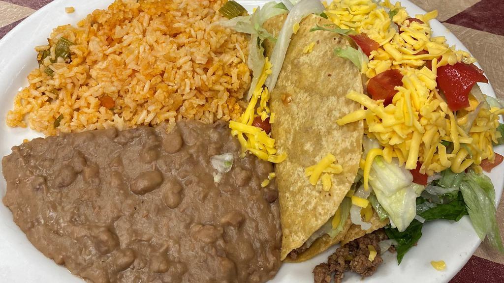 #14 Taco Plate · (2) Crispy Tacos (beef or chicken), topped with lettuce, tomato and cheese, served with Rice and Refried Beans. Add soft taco for an additional charge.