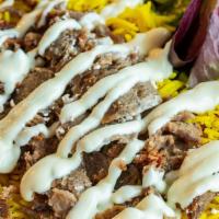 Greek Gyro Plate · Tender beef and lamb gyro served with basmati rice, side salad, fresh pita and cilantro sauce.
