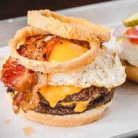 Hangover Burger · Two lean flame grilled patties, Swiss cheese, American cheese, bacon, fried onion rings, top...