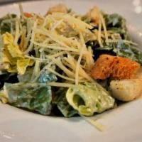 Caesar Salad · Romaine tossed with a classic Caesar dressing, topped with shredded Parmesan cheese and crou...