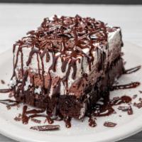 Death By Chocolate · Kahlua Chocolate brownie topped with a layer of chocolate mousse and whipped cream. Topped w...