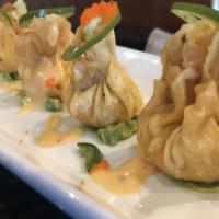 Spicy Lobster Dumpling ** · Guacemole Topped with lobster dumpling, jalapeño, masago and sweet spicy sauce.
