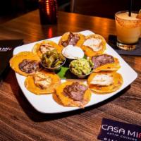 Cm Nachos · Individually prepared crispy corn tortilla chips topped with melted cheese, beans, guacamole...