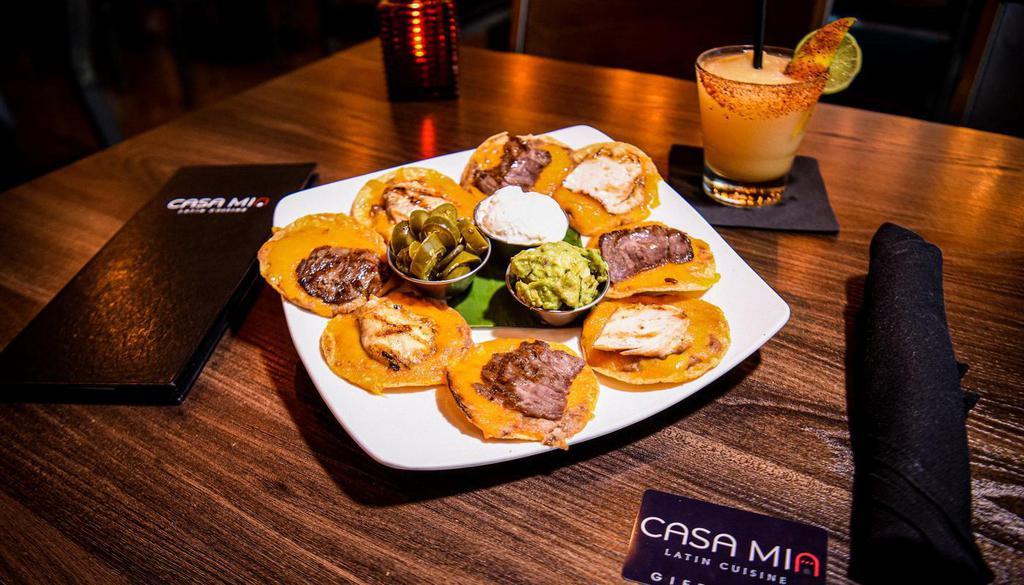 Cm Nachos · Individually prepared crispy corn tortilla chips topped with melted cheese, beans, guacamole and sour cream