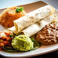 Tacos De Pollo · Three grilled chicken tacos served with spanish rice, beans guacamole and pico de gallo