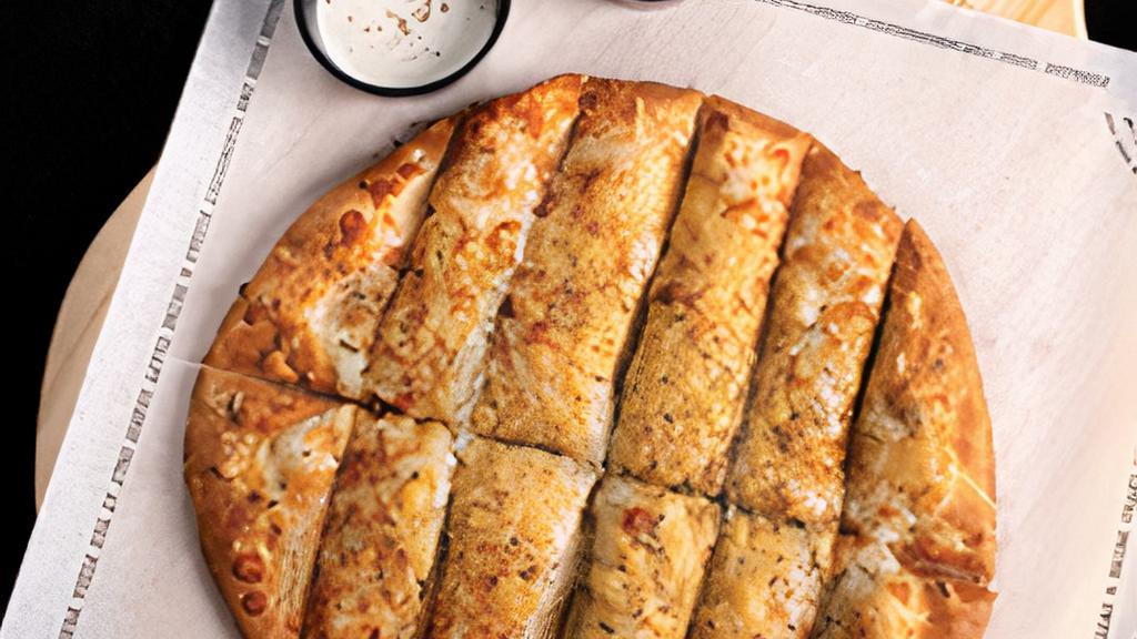 Garlic Cheesy Bread.^ · Extra virgin olive oil, fresh minced garlic, mozzarella, aged Parmesan and Italian herbs with your choice of one side sauce.