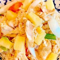 Pineapple Fried Rice · Steamed rice stir-fried with eggs, onions, tomatoes, and pineapple.