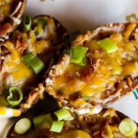 Spud Murphy'S Potato Skins · Russet potato skins topped with cheddar jack cheese, crumbles of crispy apple wood smoked ba...
