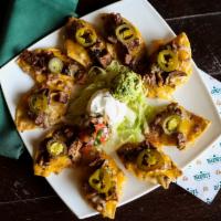 Fajita Nachos · Crispy tortilla chips topped with your choice of fajita chicken or fajita beef topped with m...