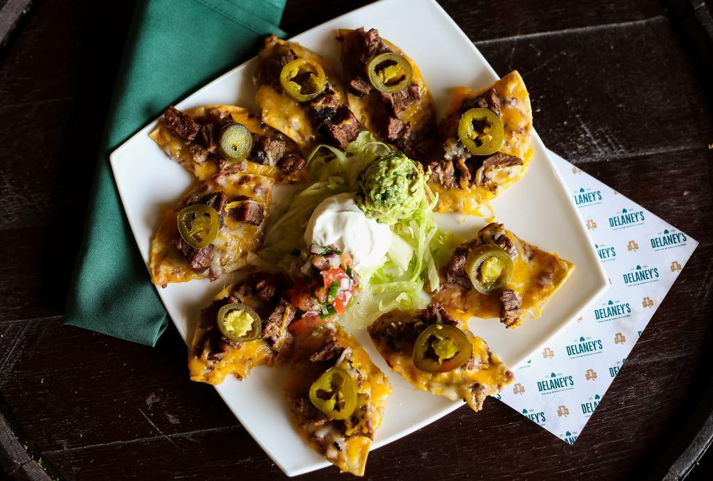 Fajita Nachos · Crispy tortilla chips topped with your choice of fajita chicken or fajita beef topped with melted cheddar jack cheese, house refried beans, and jalapeños. Served with pico de gallo and sour cream.