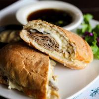 The Roast Beef Dip · Slices of slow cooked roast beef, caramelized onions and melted provolone on a toasted ciaba...