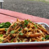 The Cowboy · Hand-cut Fries or Tortilla Chips with Queso, Bacon, Green Onions & Fresh Jalapeño.