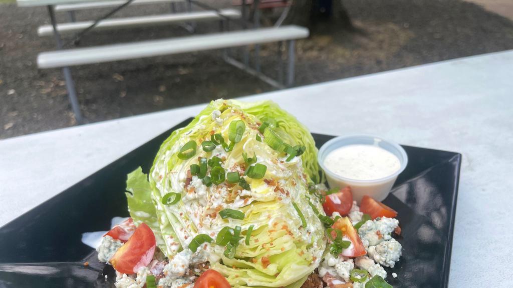 Wedge Salad · Wedge Salad topped Blue Cheese Crumble, Bacon, Tomato, Green Onion & Ranch Dressing. Add Chicken for an additional charge.