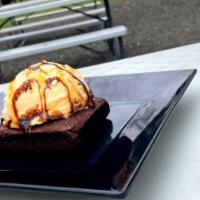 Brownie A La Mode · Texas size brownie topped with vanilla ice cream and drizzled with caramel and chocolate sau...