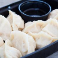 Pork Dumplings · An authentic, simple but delicious classic! Housemade hand rolled wrappers with pork, napa c...