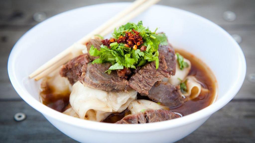 Beef Wonton Soup · A full order of 10 fresh pork wontons submerged in beef broth, with melt-in-you-mouth beef tenderloin, fresh herbs and our house-made toasted chili oil.