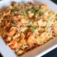 Cajun Faith · Homemade pasta tossed with chicken, crawfish, shrimp, and sausage in a creamy tomato seafood...