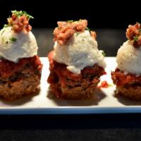 Meatloaf Cupcakes · Mini meatloaves topped with mashed potatoes, bacon & chives. Served with garlic roasted mush...