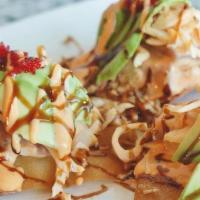 Spicy Ahi Poke Nachos · Layers of spicy tuna, crab, avocado, fried onions, and masago on wanton chips topped with sp...