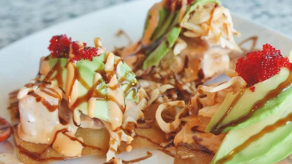 Spicy Ahi Poke Nachos · Layers of spicy tuna, crab, avocado, fried onions, and masago on wanton chips topped with spicy mayo & eel sauce.