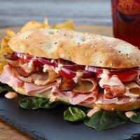 Spicy Turkey Club · Pan Roasted Turkey Breast, Ham, Hardwood Smoked Bacon, Tomatoes, Red Onion, Spicy Ranch Dres...