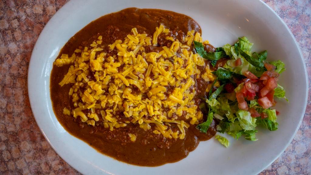 Tex-Mex Enchiladas · Three famous San Antonio style enchiladas, filled with your choice: beef, chicken, or cheese. Topped with traditional enchilada gravy and chili con carne. Served with Spanish rice and beans. (Comes with three of the same filling.)

*Entrée comes with 1 tortilla.