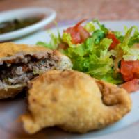 Empanada De Carne · Fried turnover filled with beef and olives served with Chimichurri Sauce