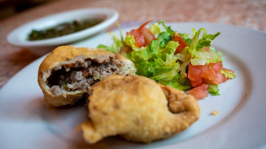 Empanada De Carne · Fried turnover filled with beef and olives served with Chimichurri Sauce