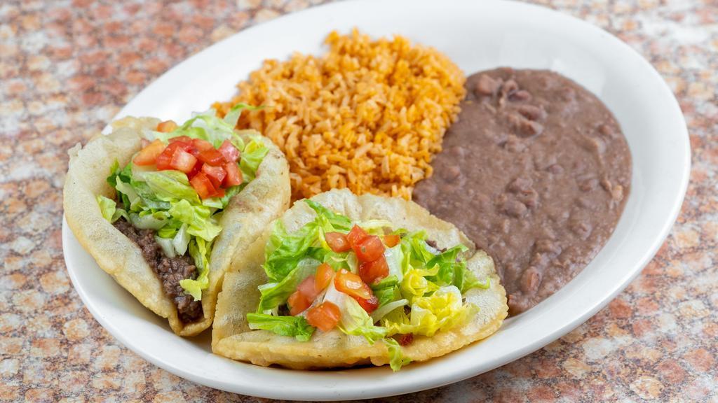 Puffy Taco Plate · Two puffy tacos with your choice of filling: beef, chicken, bean, or guacamole. Served with Spanish rice and refried beans. 

*Entrée comes with 1 tortilla.