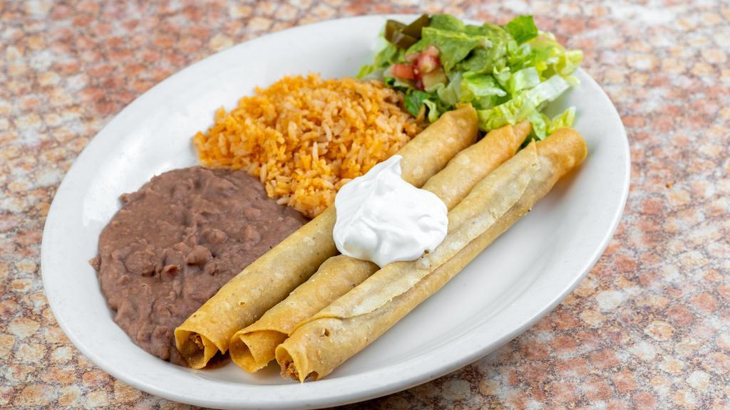 Crispy Flautas · Three corn tortillas rolled and filled with shredded chicken and fried to a golden crisp. Topped with sour cream and served with Spanish rice, refried beans, and guacamole salad.

*Entrée comes with 1 tortilla.