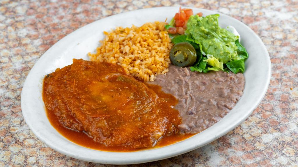 Chile Relleno · Classic soufflé-battered poblano filled with beef or cheese and topped with a mild ranchero sauce. Served with Spanish rice, refried beans, and guacamole salad.

*Entrée comes with 1 tortilla.
