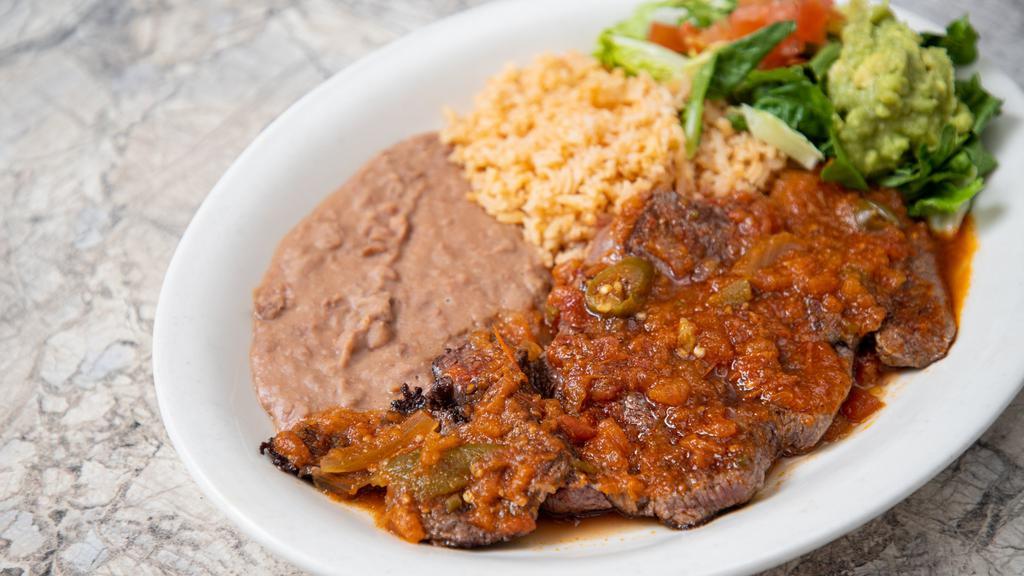 Beef Steak Ranchero · Beef tenderloin topped with spicy ranchero sauce. Served with Spanish rice, refried beans, and guacamole salad.

*Entrée comes with 1 tortilla.